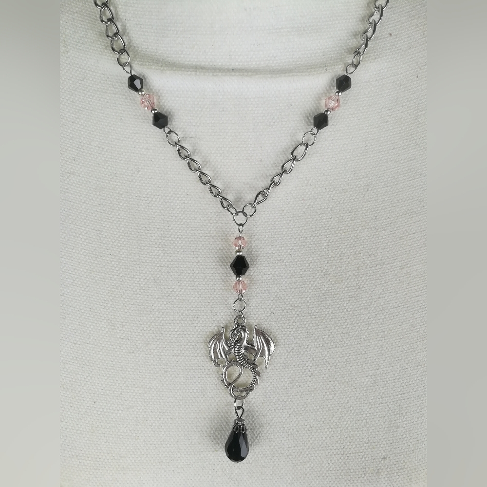 Dragon fantasy theme necklace light pink and black faceted glass beads.